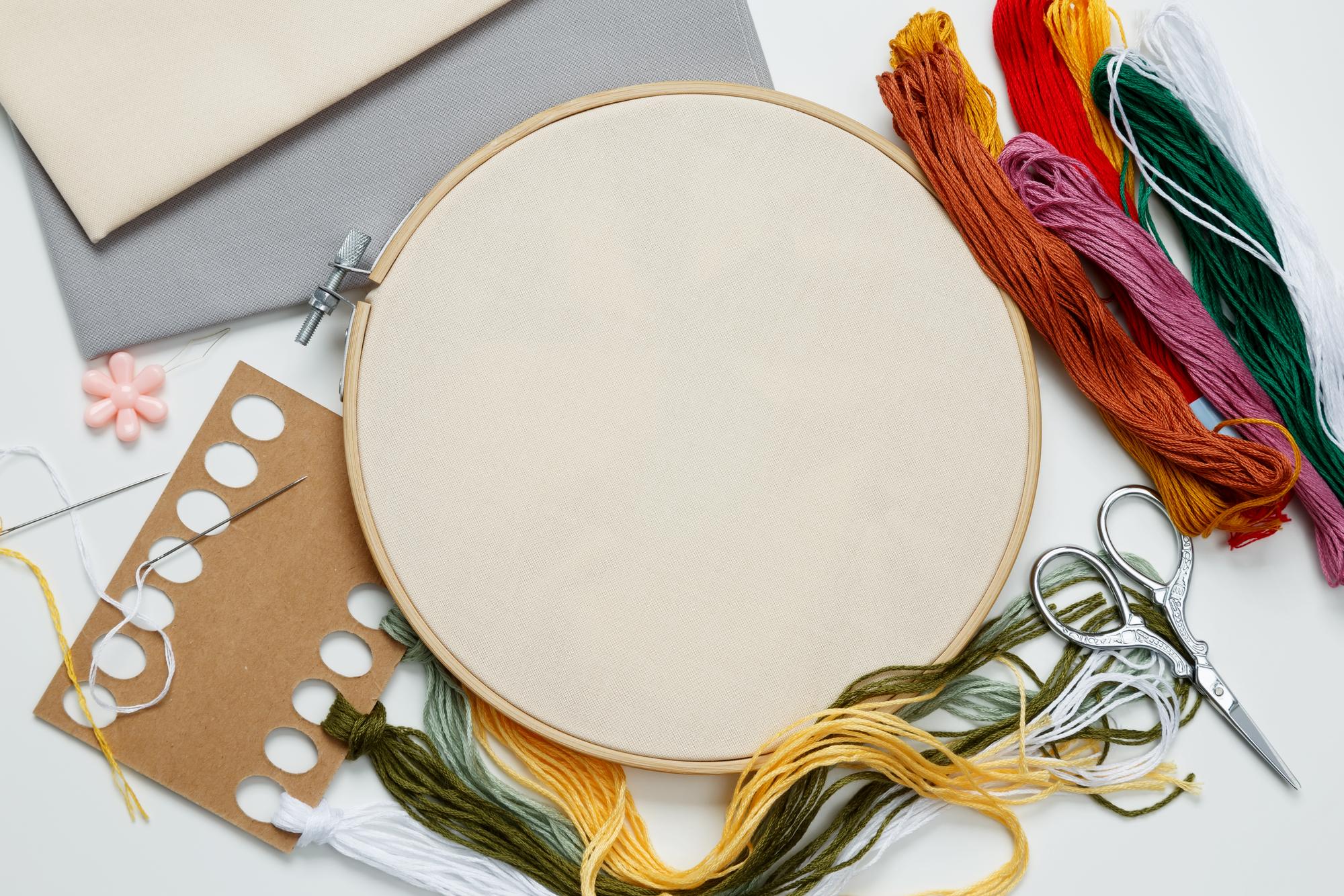 Embroidery studio workspace with threads and hoops