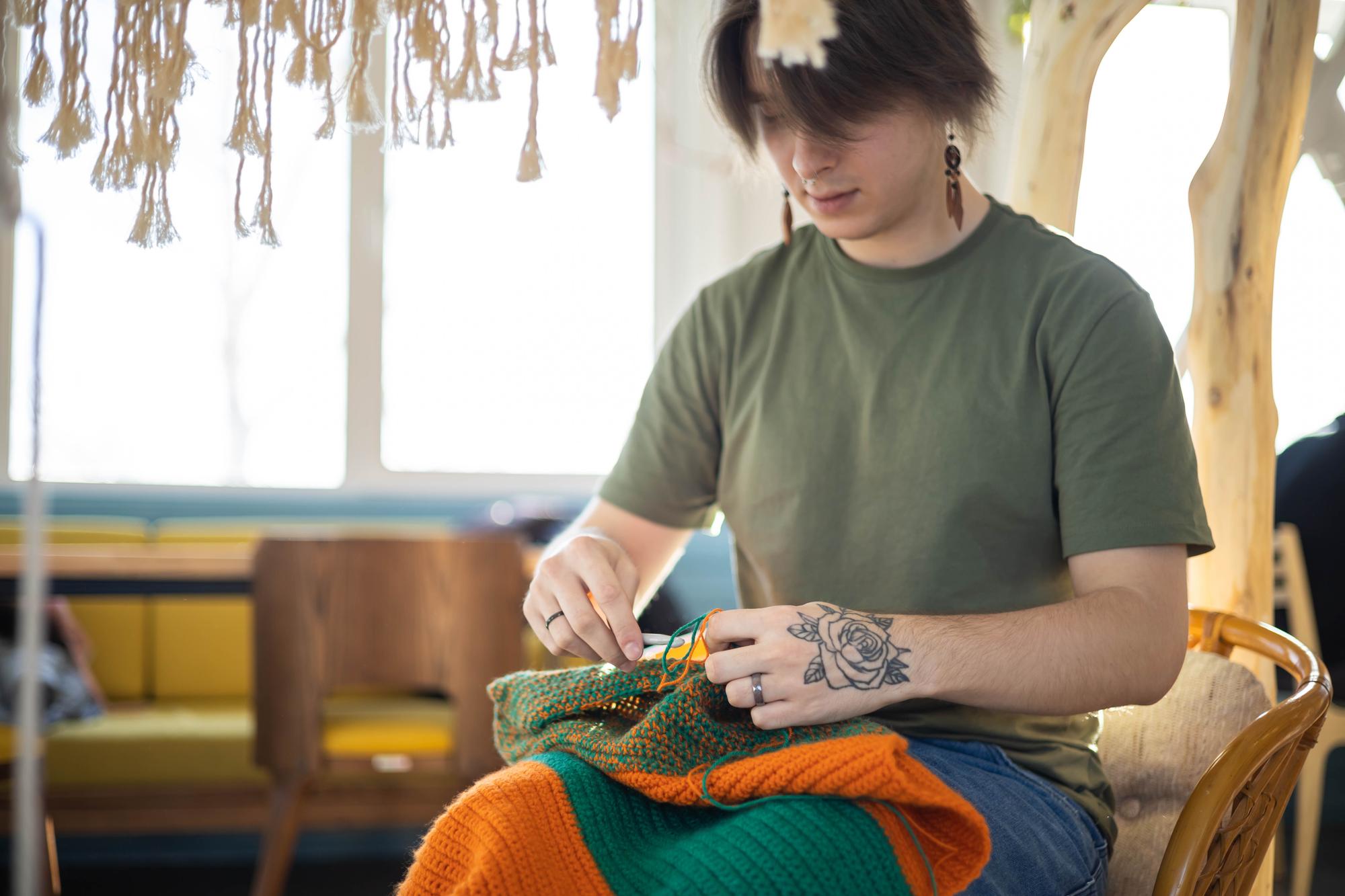 Portrait of lead artisan stitching